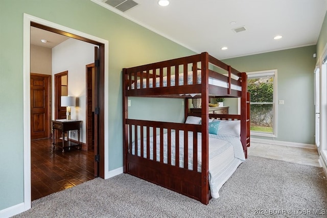 bedroom with ornamental molding and dark hardwood / wood-style flooring