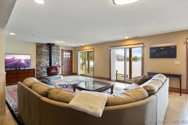 tiled living room featuring a wood stove