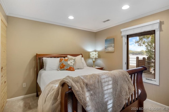 carpeted bedroom featuring crown molding