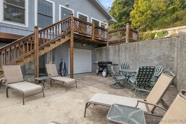 view of patio / terrace with area for grilling, a garage, and a deck