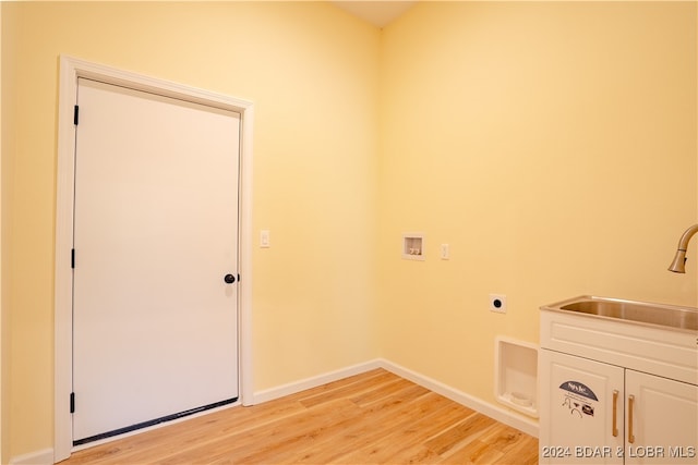 laundry room with cabinets, hookup for an electric dryer, washer hookup, light hardwood / wood-style floors, and sink