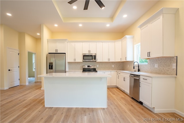 kitchen featuring stainless steel appliances, light wood-type flooring, and a kitchen island