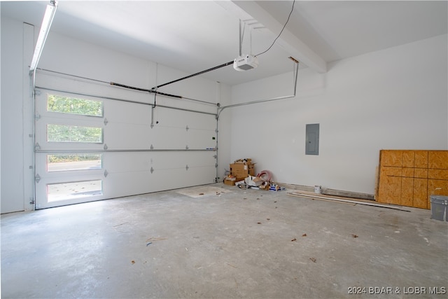 garage with a garage door opener and electric panel