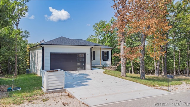 view of front of house with a front yard and a garage