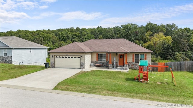 single story home with a front yard, a garage, and a playground