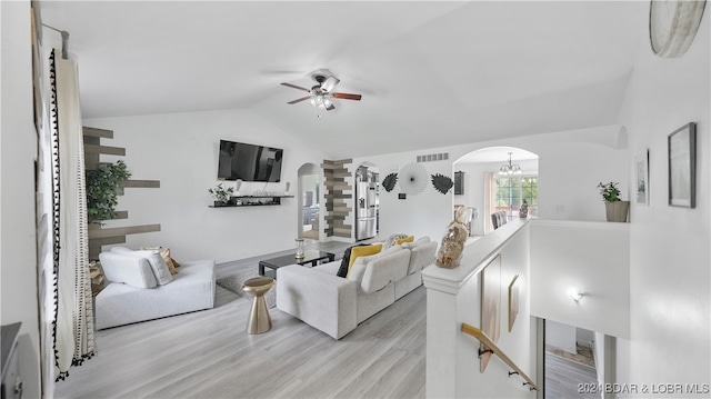 living room featuring light hardwood / wood-style flooring, lofted ceiling, and ceiling fan