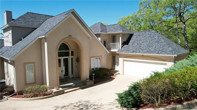 view of front of house with french doors and a garage