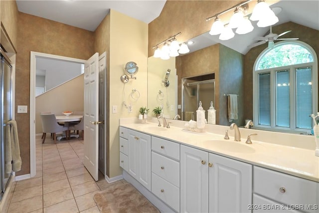 bathroom with vaulted ceiling, a shower with shower door, tile patterned flooring, vanity, and ceiling fan