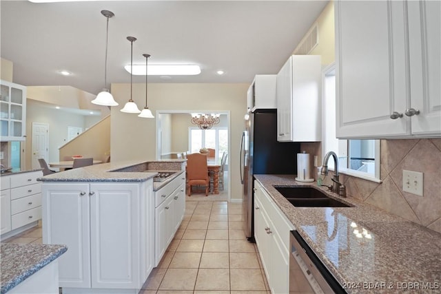 kitchen featuring pendant lighting, sink, white cabinets, and appliances with stainless steel finishes