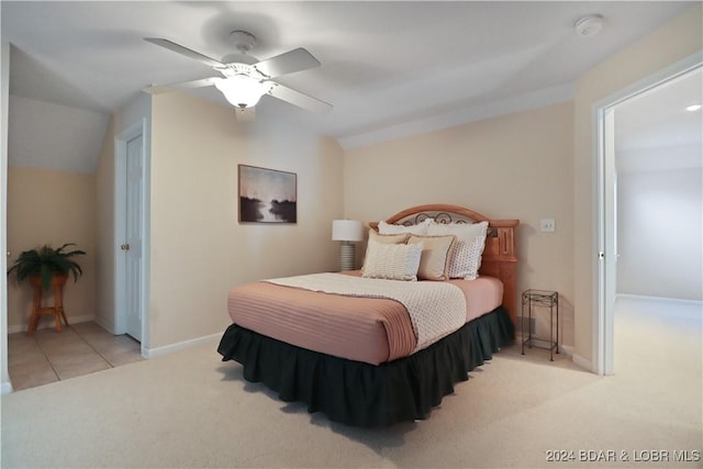 bedroom featuring light carpet, vaulted ceiling, and ceiling fan