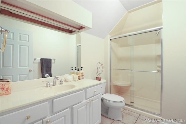 bathroom with vaulted ceiling, a shower with shower door, tile patterned flooring, vanity, and toilet