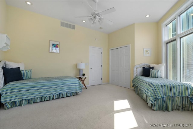 bedroom with a closet, ceiling fan, and carpet