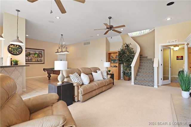 carpeted living room with ceiling fan