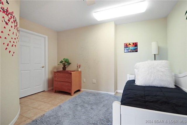 tiled bedroom with ceiling fan