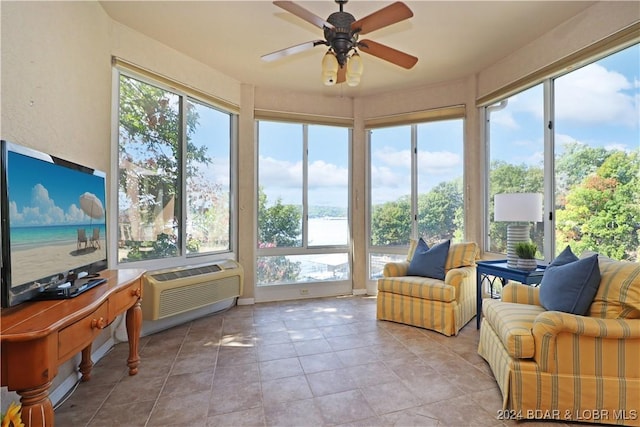 sunroom featuring a water view, ceiling fan, and an AC wall unit