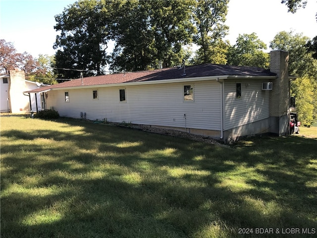 rear view of house with a yard