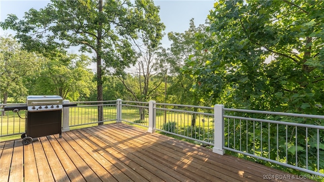 wooden deck featuring a grill