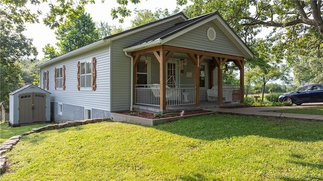 bungalow-style home with a storage shed, a porch, and a front yard