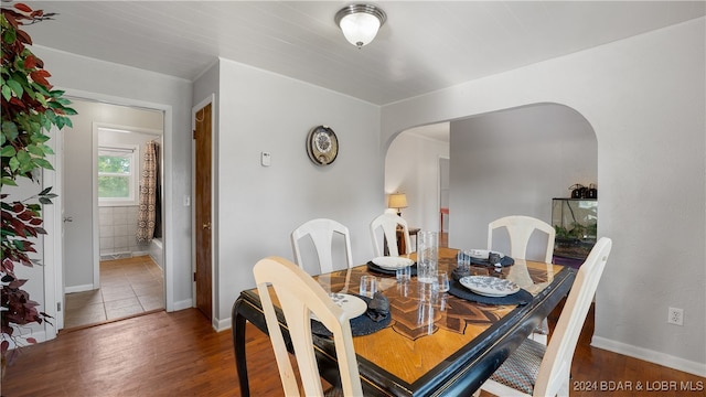 dining space with dark hardwood / wood-style flooring