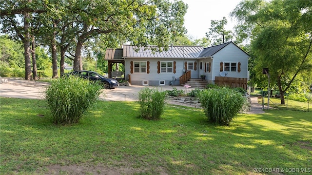 back of house with a lawn