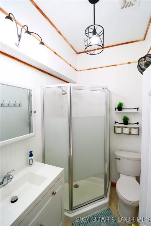 bathroom with tile patterned flooring, vanity, toilet, and a shower with door