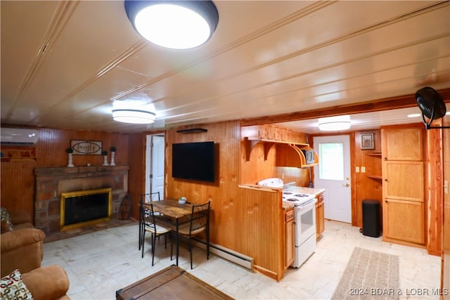 kitchen with a wall unit AC, white electric stove, wooden walls, and a stone fireplace