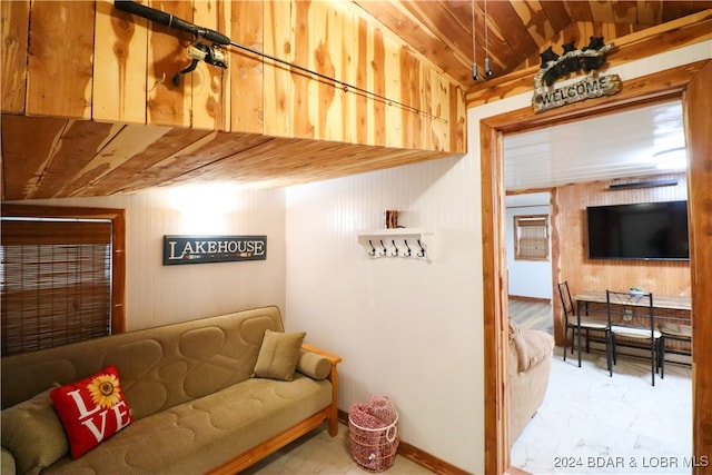 living room featuring wood walls and a baseboard heating unit