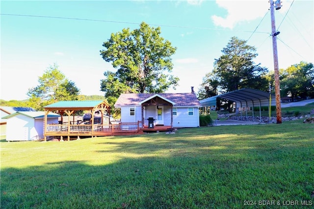 view of yard with a carport, a storage shed, and a wooden deck