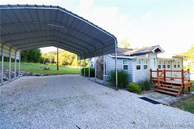 view of parking / parking lot with a carport and a lawn