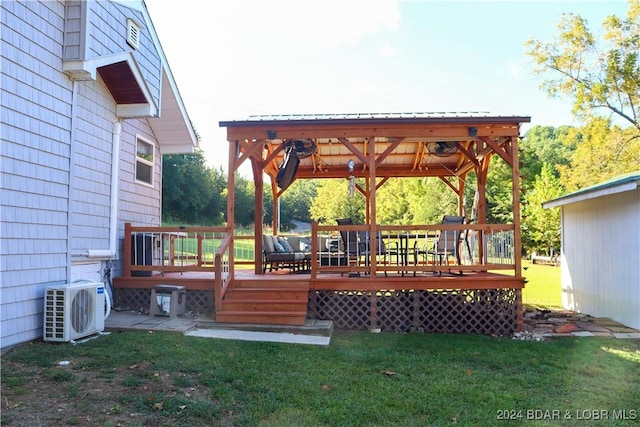 wooden terrace with a lawn and ac unit