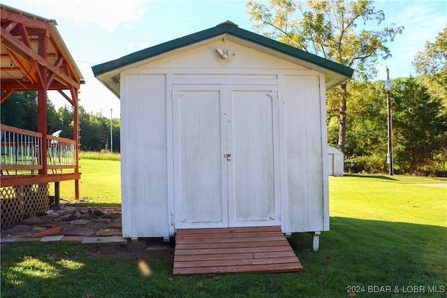 view of outdoor structure featuring a lawn