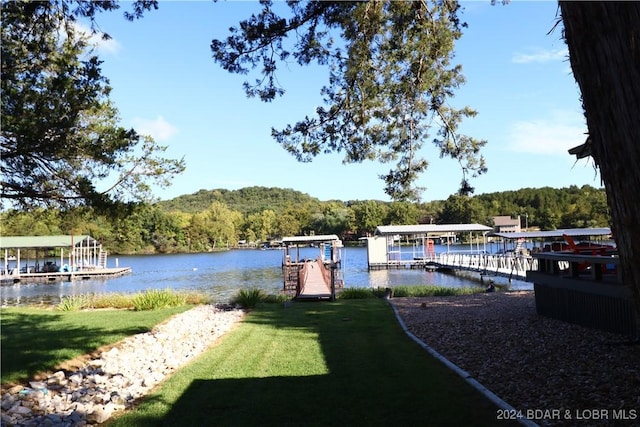 view of dock featuring a yard and a water view