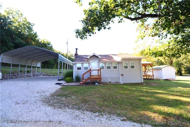 exterior space with a front lawn, a shed, and a carport