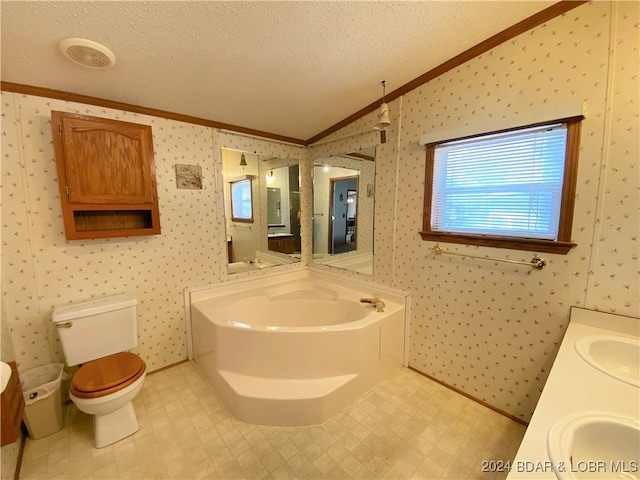 bathroom with ornamental molding, a textured ceiling, toilet, and a tub