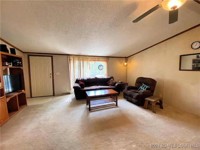 living room featuring light carpet, ceiling fan, ornamental molding, and a textured ceiling