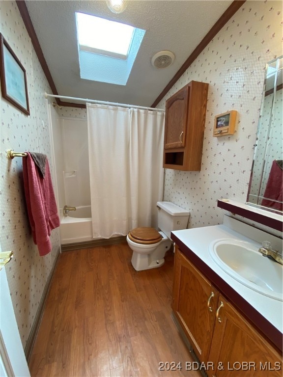 full bathroom with toilet, hardwood / wood-style floors, shower / bath combo, ornamental molding, and vanity