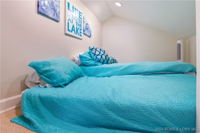 carpeted bedroom with lofted ceiling