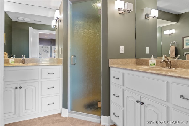 bathroom featuring walk in shower, tile patterned flooring, and vanity