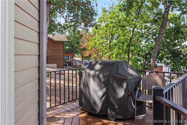 wooden terrace featuring a grill