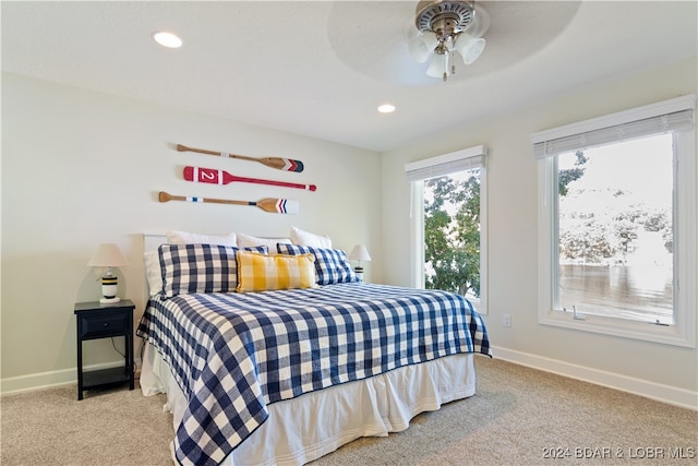 bedroom with ceiling fan and light colored carpet