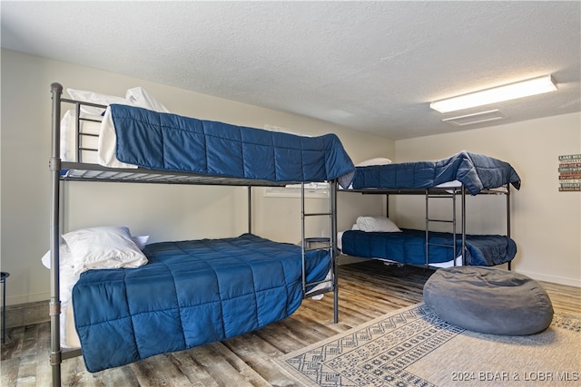 bedroom featuring a textured ceiling and hardwood / wood-style flooring