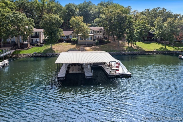 dock area featuring a lawn and a water view