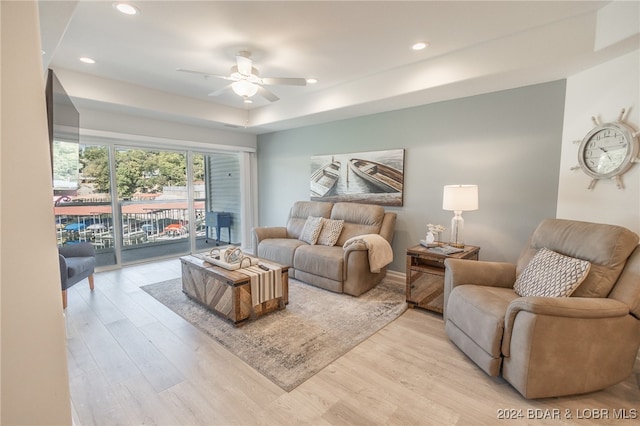 living room featuring light hardwood / wood-style floors and ceiling fan