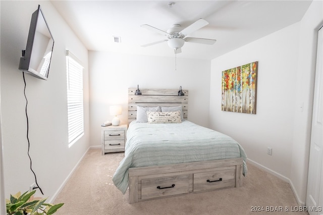 bedroom featuring light carpet and ceiling fan