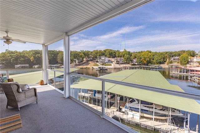 balcony featuring a water view and ceiling fan