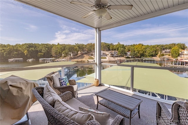 balcony featuring a water view, outdoor lounge area, and ceiling fan