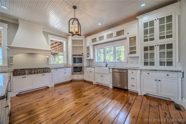 kitchen featuring plenty of natural light, stainless steel appliances, and white cabinets