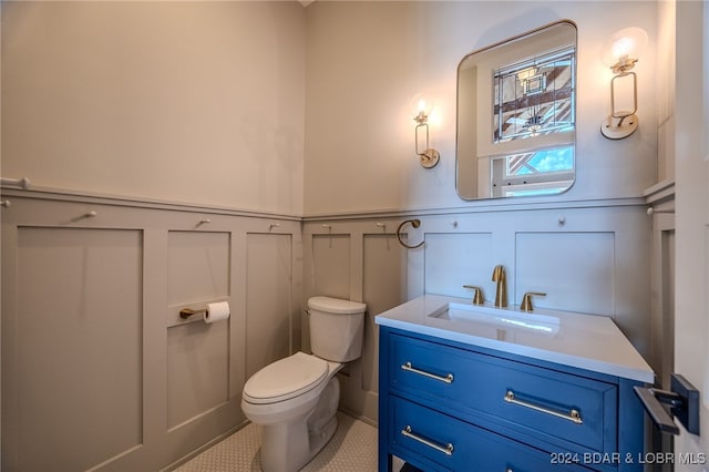 bathroom with tile patterned floors, vanity, and toilet