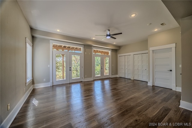 unfurnished living room with french doors, dark hardwood / wood-style flooring, and ceiling fan