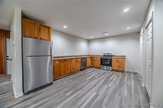 kitchen featuring sink, stainless steel appliances, and light hardwood / wood-style floors